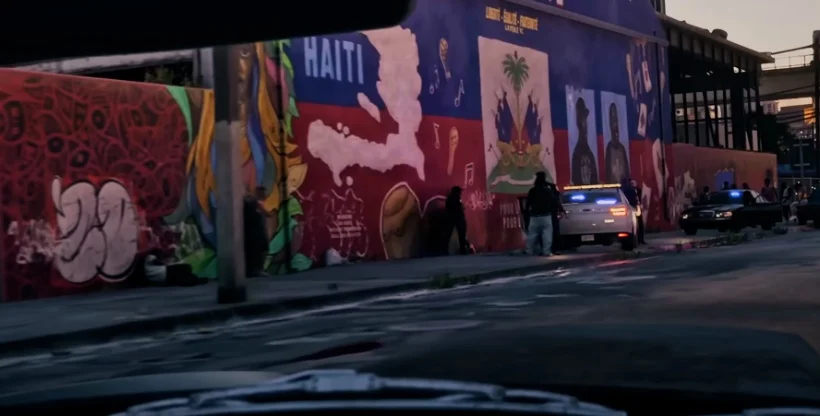 A colorful mural painted on a building wall in La Perle.