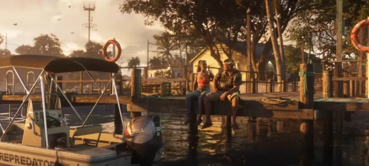 Lucia and Jason sitting on a wooden dock overlooking the water at sunset.